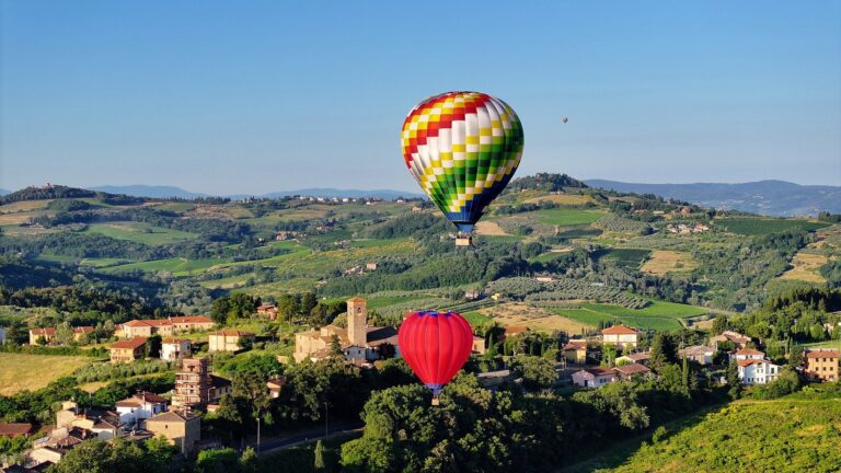 Colorful hot air balloon flight over the hills and villages of the Tuscan countryside