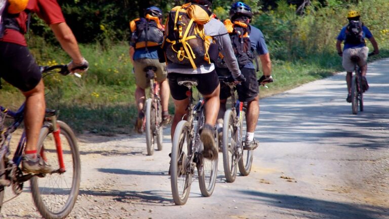 Group of tourists riding mountain bikes during a guided dirt road tour in Tuscany